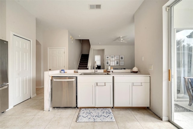 kitchen with plenty of natural light, white cabinetry, sink, and appliances with stainless steel finishes