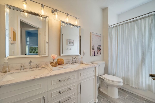 full bathroom featuring toilet, vanity, hardwood / wood-style floors, and shower / bathtub combination with curtain