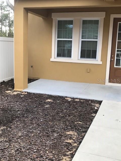 6560 Candied Peel Aly, Winter Garden, FL 34787 - view of exterior entry with fence and stucco siding