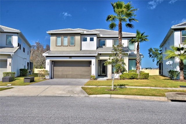 view of front facade with a garage and a front lawn