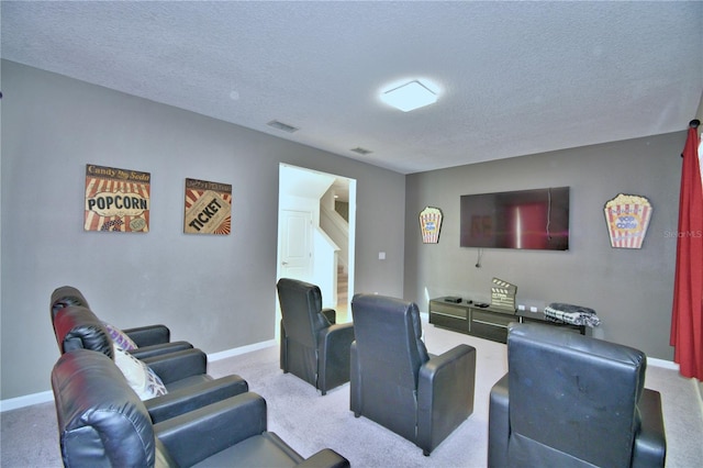 carpeted home theater featuring a textured ceiling