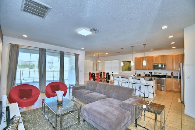 tiled living room with a textured ceiling