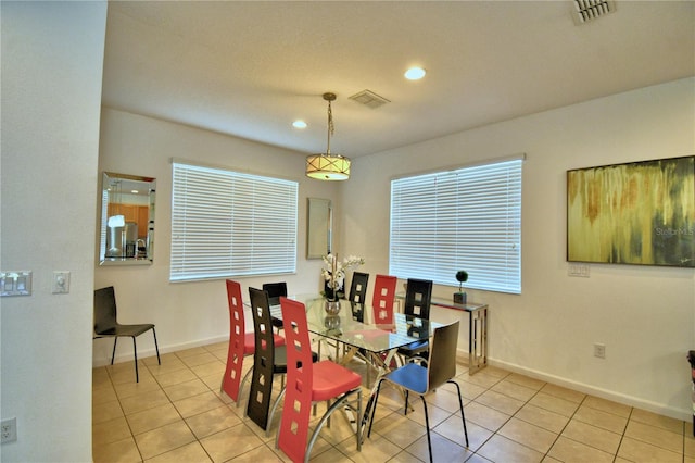 dining space featuring light tile patterned flooring