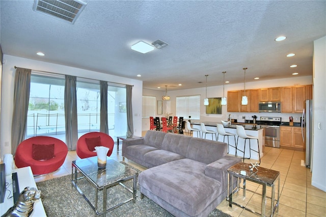 living room with light tile patterned flooring and a textured ceiling