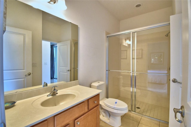 bathroom with walk in shower, toilet, vanity, and tile patterned floors