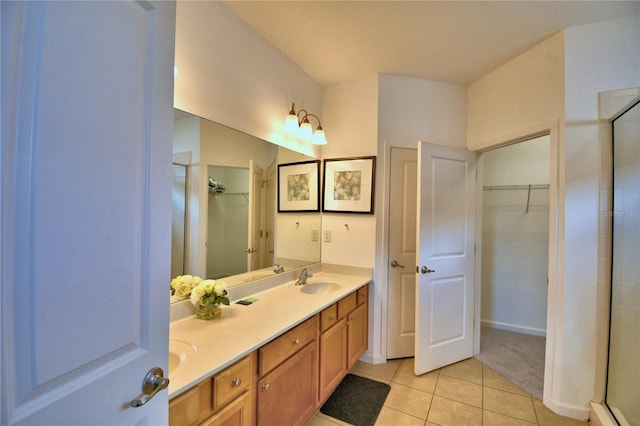 bathroom featuring an enclosed shower, vanity, and tile patterned floors