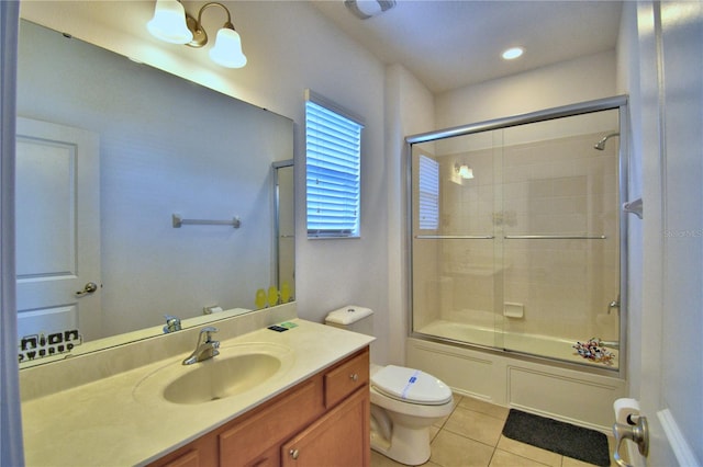 full bathroom featuring shower / bath combination with glass door, tile patterned flooring, toilet, and vanity