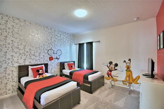 bedroom with a textured ceiling and light colored carpet