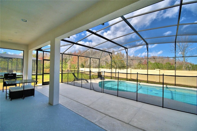 view of swimming pool with a patio area and a lanai