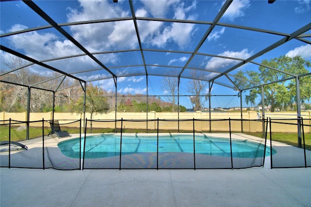 view of pool with a patio area and a lanai