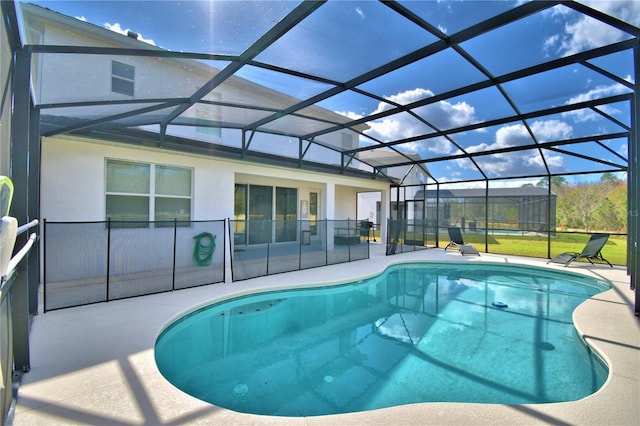 view of pool featuring a patio and glass enclosure