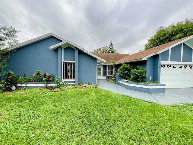 ranch-style house featuring a garage and a front lawn