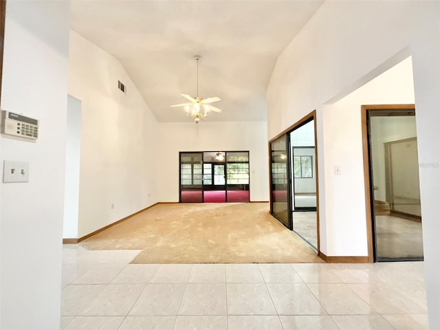 unfurnished room featuring high vaulted ceiling, light colored carpet, and ceiling fan