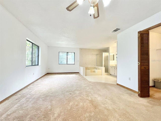 empty room with light carpet and ceiling fan