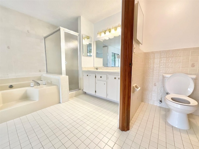 full bathroom with toilet, separate shower and tub, tile patterned floors, tile walls, and vanity