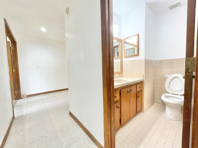 bathroom featuring toilet, vanity, and tile patterned floors