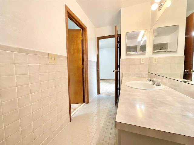 bathroom featuring vanity, tile patterned floors, and tile walls