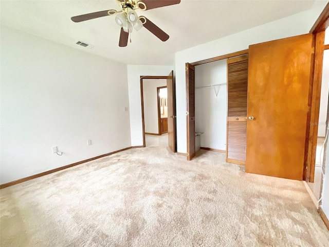 unfurnished bedroom featuring a closet, light carpet, and ceiling fan