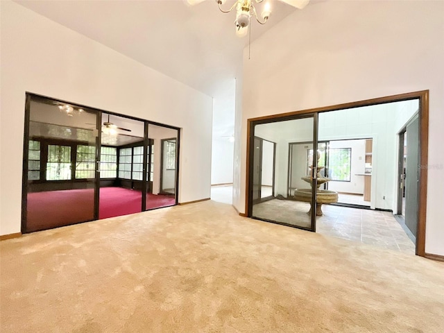 interior space featuring high vaulted ceiling and ceiling fan