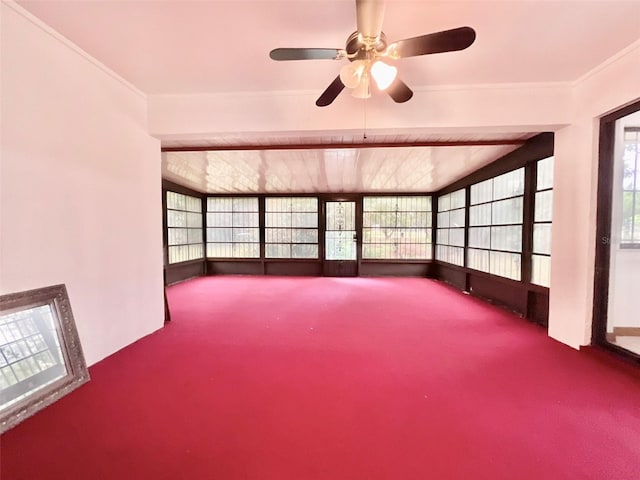 unfurnished sunroom with ceiling fan and plenty of natural light