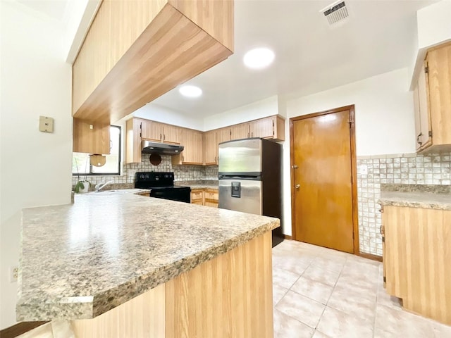 kitchen featuring backsplash, stainless steel refrigerator, black electric range oven, light brown cabinetry, and kitchen peninsula