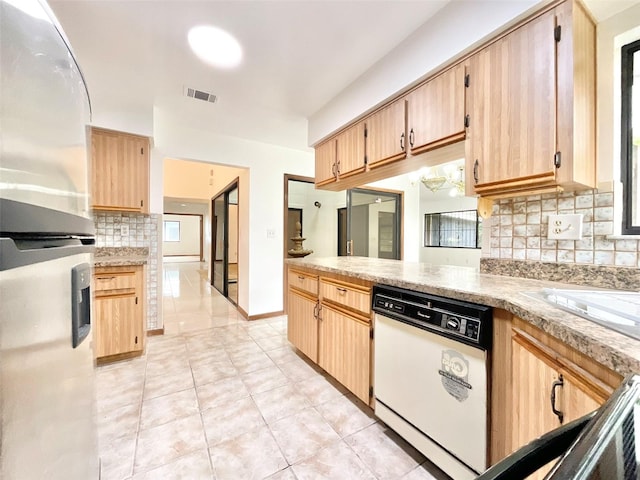 kitchen with white dishwasher, light tile patterned flooring, stainless steel fridge, and decorative backsplash