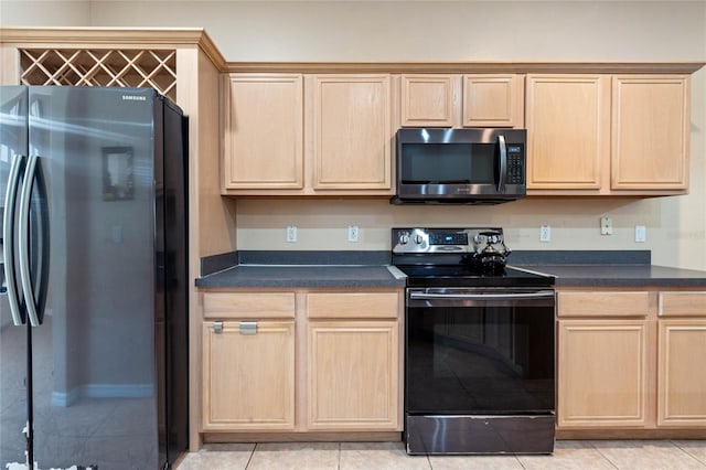 kitchen with light brown cabinets, stainless steel appliances, and light tile patterned flooring