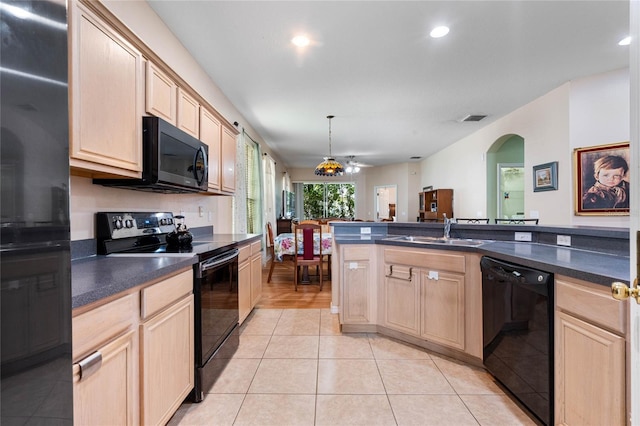 kitchen featuring ceiling fan, light brown cabinetry, black appliances, and decorative light fixtures