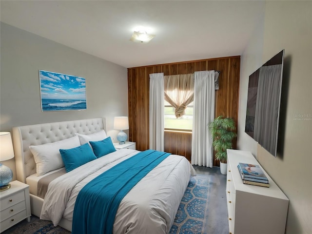 bedroom featuring wood walls