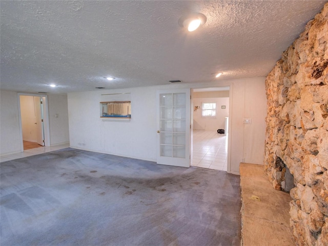 interior space featuring carpet and a textured ceiling