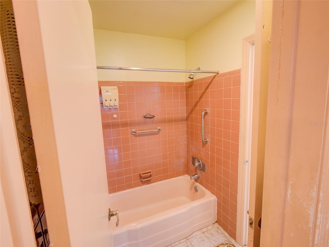 bathroom featuring tile walls, tile patterned flooring, and tiled shower / bath combo