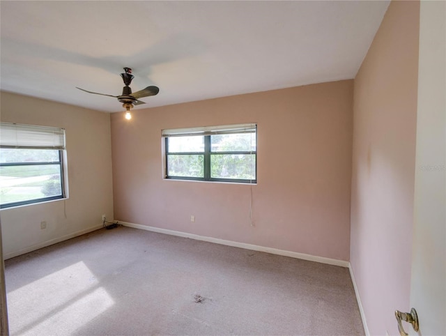 unfurnished room with ceiling fan, light carpet, and a healthy amount of sunlight