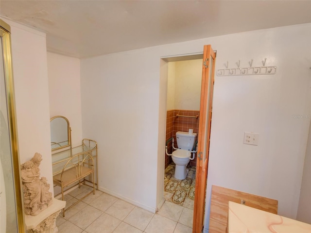 bathroom with toilet and tile patterned floors