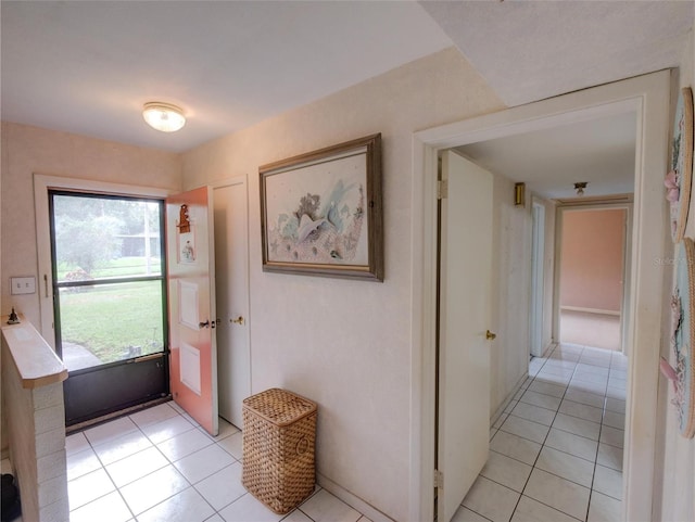 doorway with light tile patterned floors