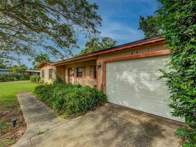 ranch-style house featuring a garage and a front yard