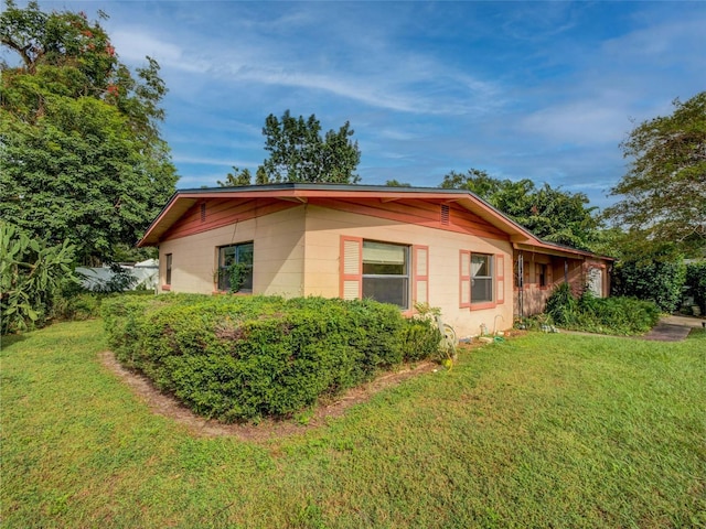 view of property exterior with a yard