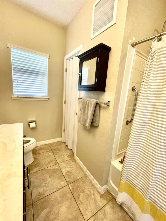 full bathroom featuring shower / bath combo, tile patterned floors, a textured ceiling, toilet, and vanity