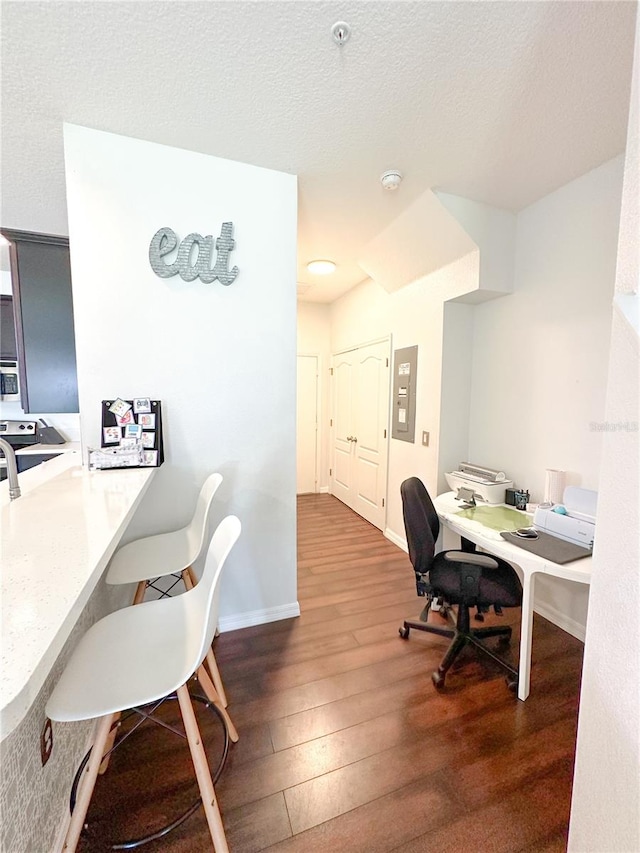 office featuring dark hardwood / wood-style flooring and a textured ceiling