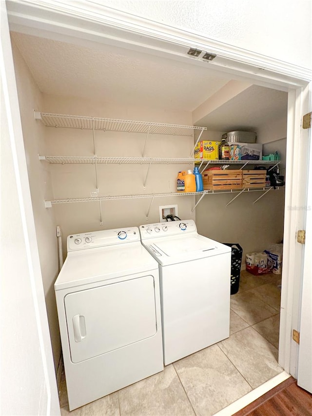 washroom featuring hardwood / wood-style flooring and washing machine and dryer