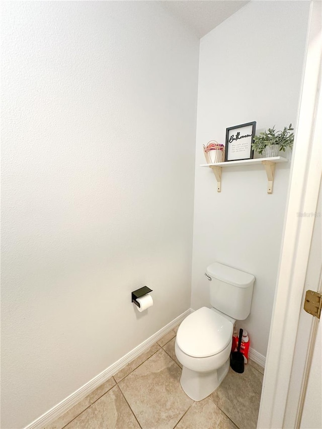 bathroom with tile patterned flooring and toilet