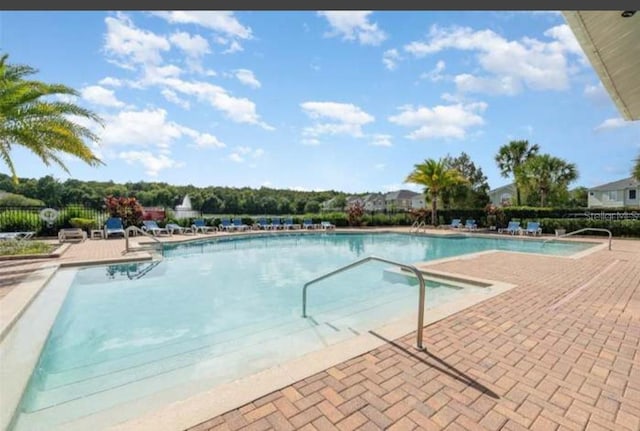 view of swimming pool featuring a patio area