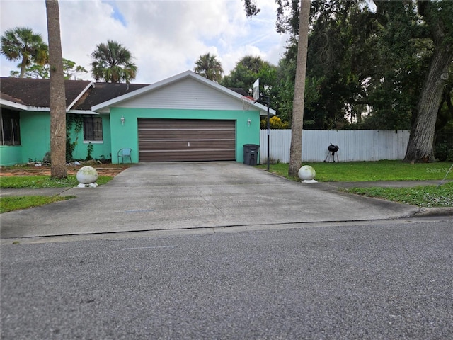 single story home featuring a garage and a front yard