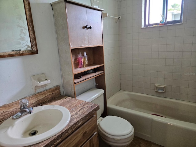 full bathroom featuring vanity, toilet, and tiled shower / bath combo