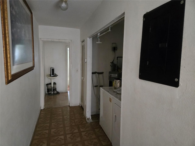 hallway with electric panel and washing machine and clothes dryer