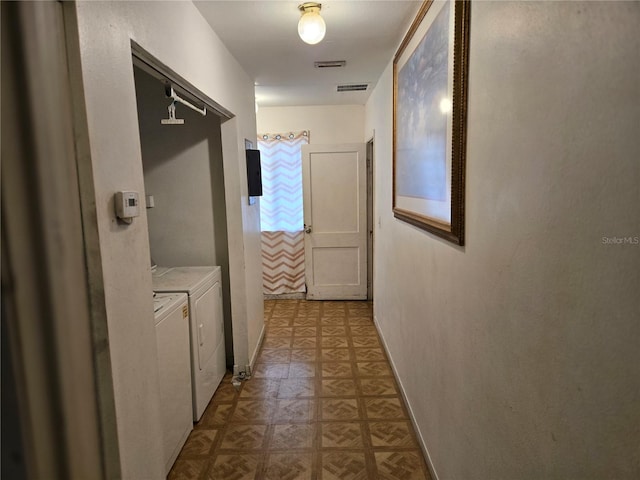 hallway featuring washing machine and dryer