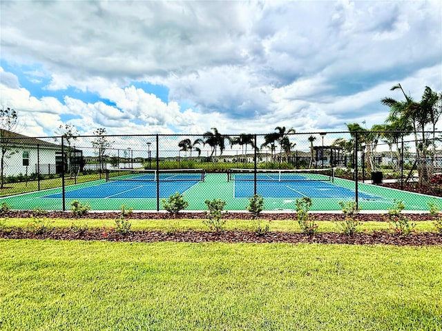 view of sport court featuring a lawn