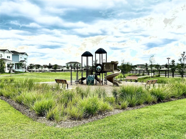 view of jungle gym featuring a lawn