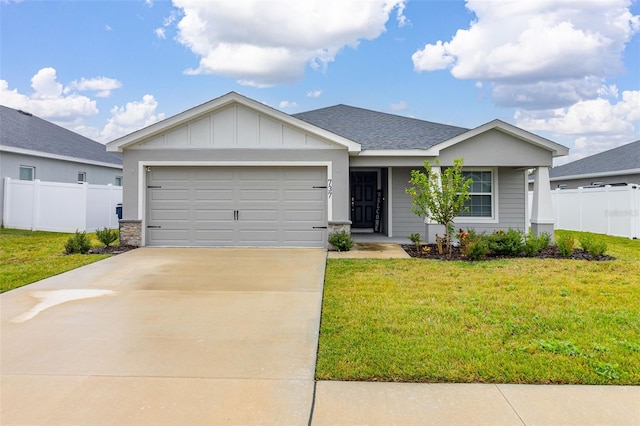 ranch-style house featuring a garage and a front lawn