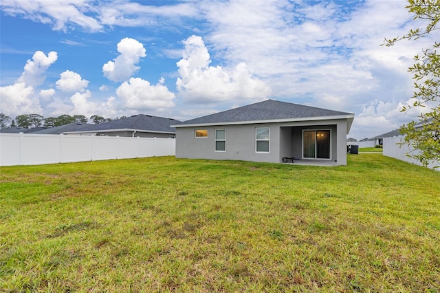 rear view of property featuring a yard