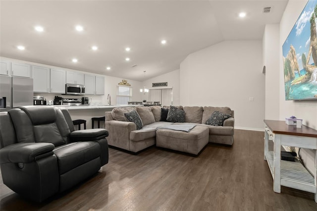 living room featuring dark hardwood / wood-style flooring, lofted ceiling, and sink